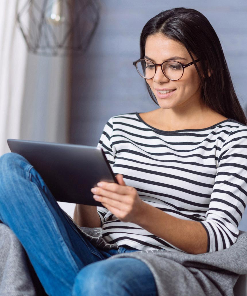 image of woman smiling and holding a tablet