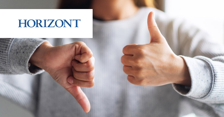 image of woman holding thumbs up and thumbs down